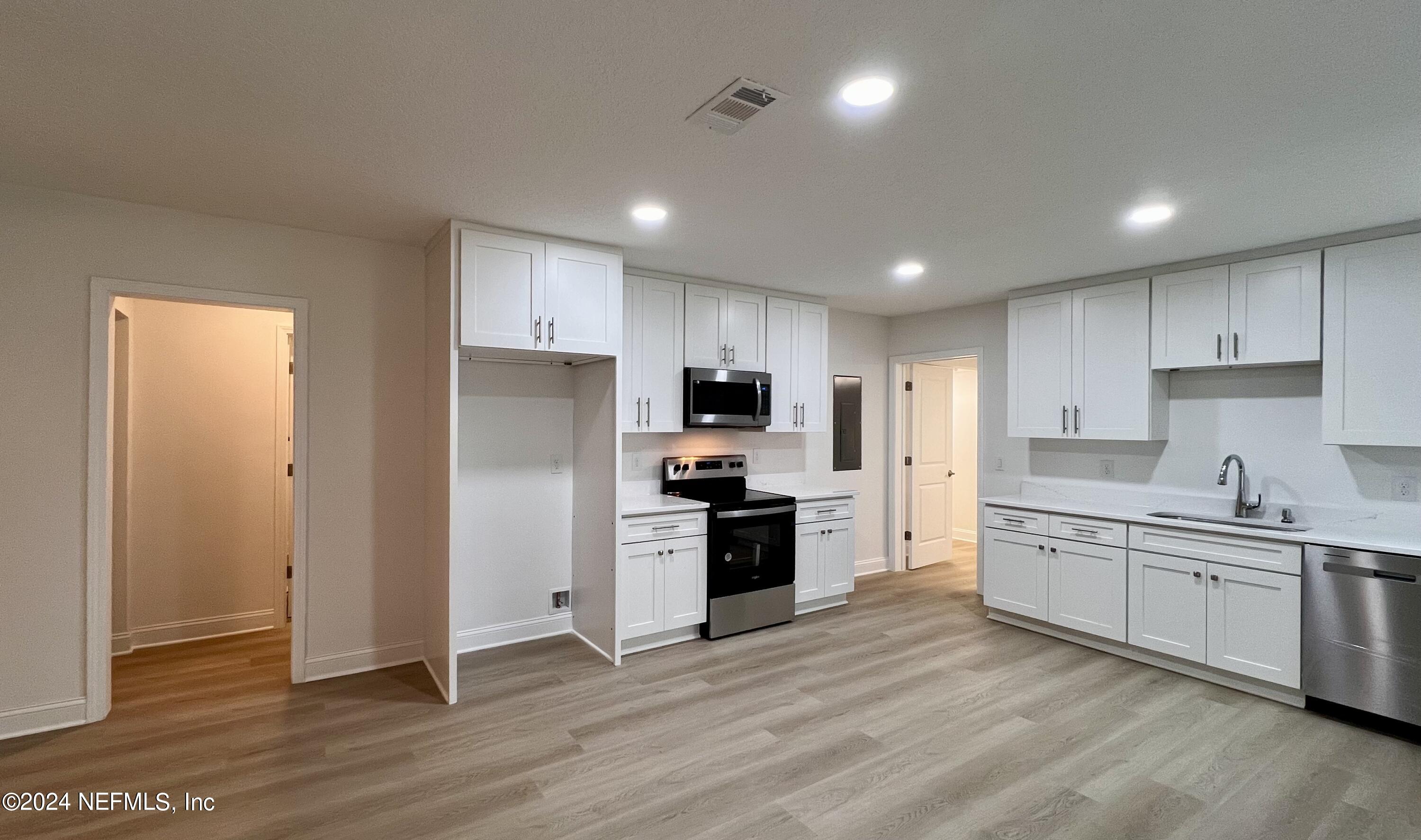 1833 Bartram Road Jacksonville, FL 32207 - Photo 4 of 50 a kitchen with a sink a refrigerator and a stove top oven