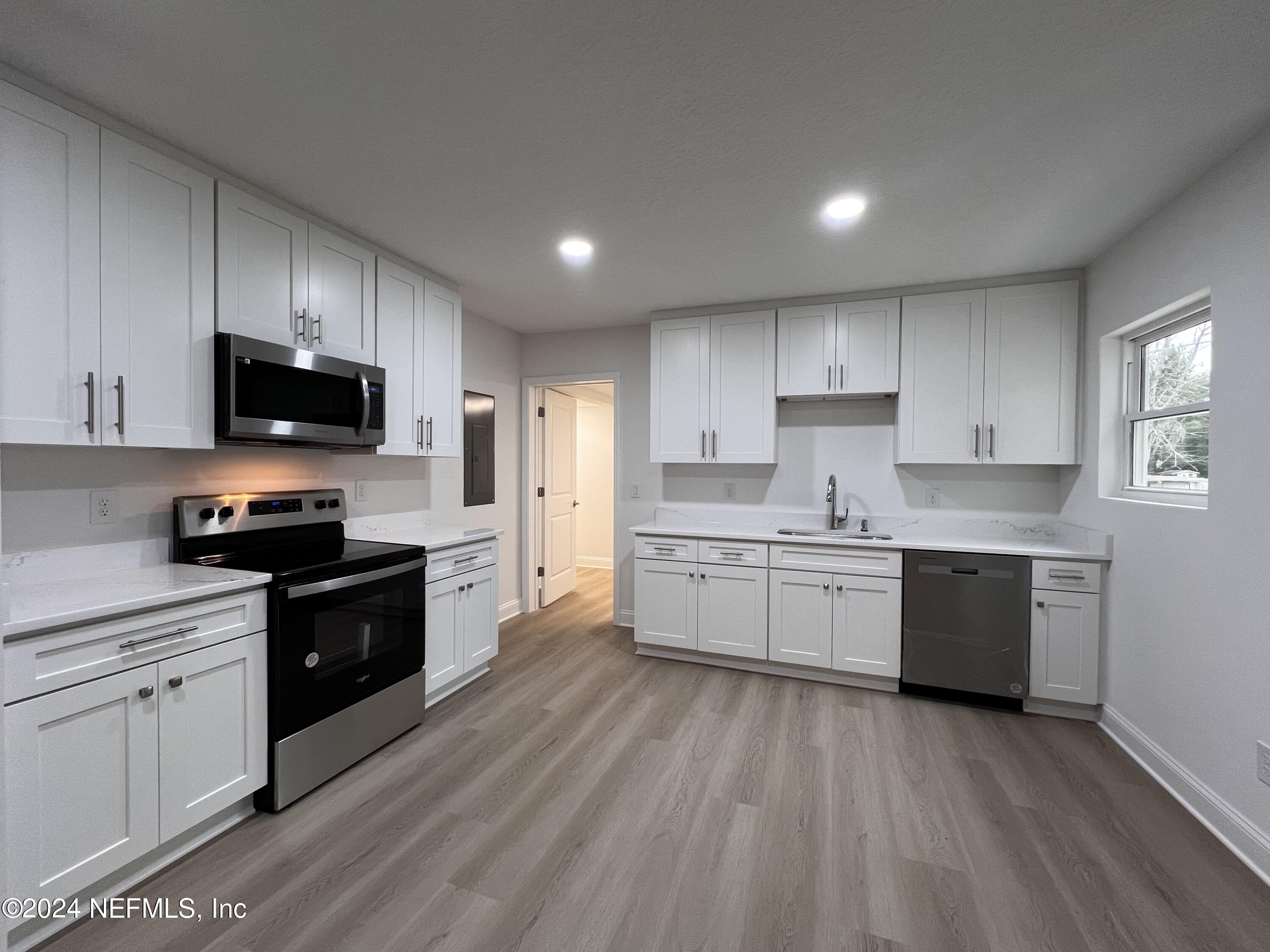 1833 Bartram Road Jacksonville, FL 32207 - Photo 5 of 50 a kitchen with sink a microwave and cabinets