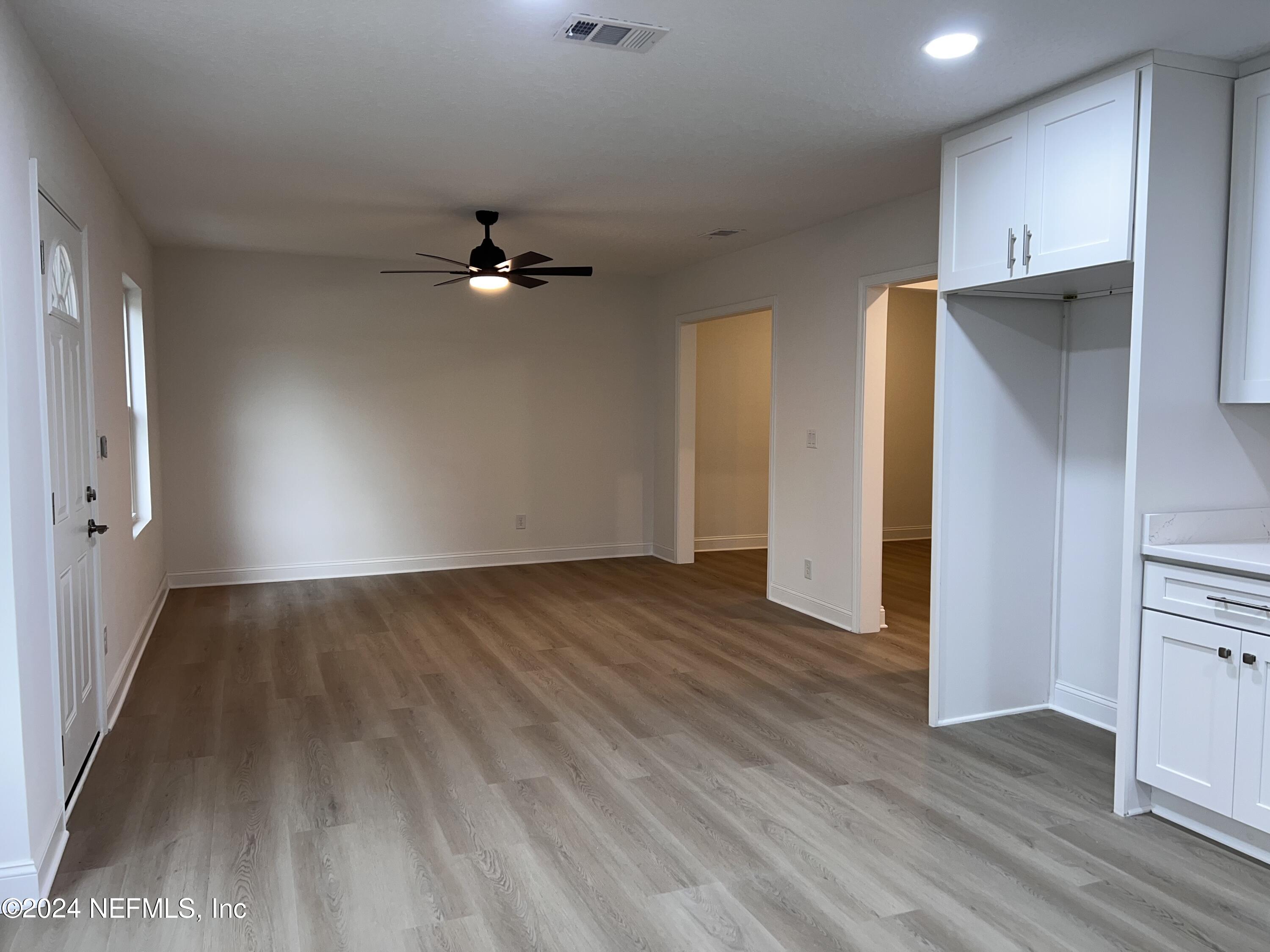 1833 Bartram Road Jacksonville, FL 32207 - Photo 9 of 50 wooden floor in an empty room with a window