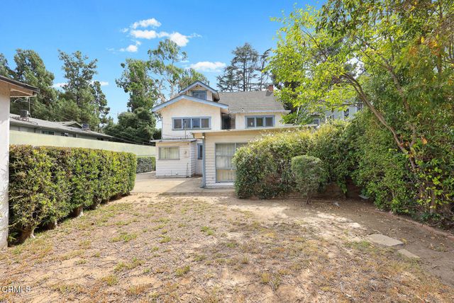 an aerial view of a house with yard swimming pool and outdoor seating
