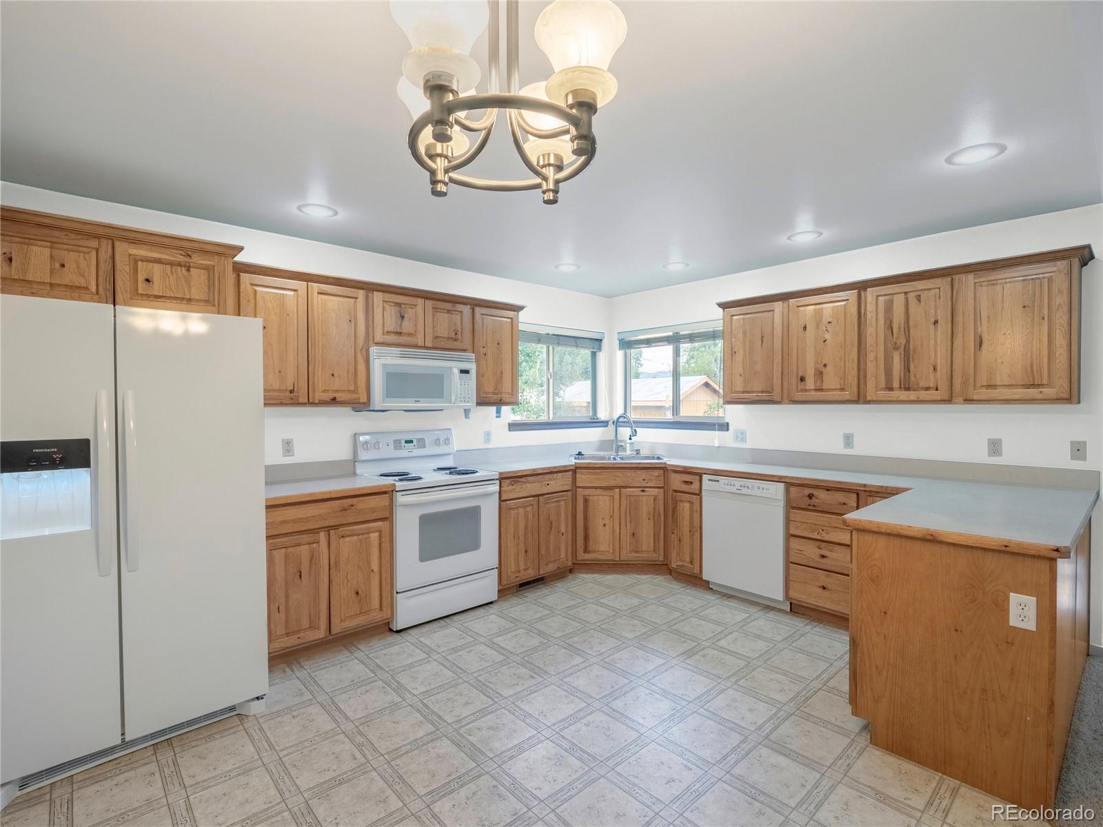 1436 H Street, Unit D Salida, CO 81201 - Photo 11 of 31 a large kitchen with cabinets wooden floor and stainless steel appliances