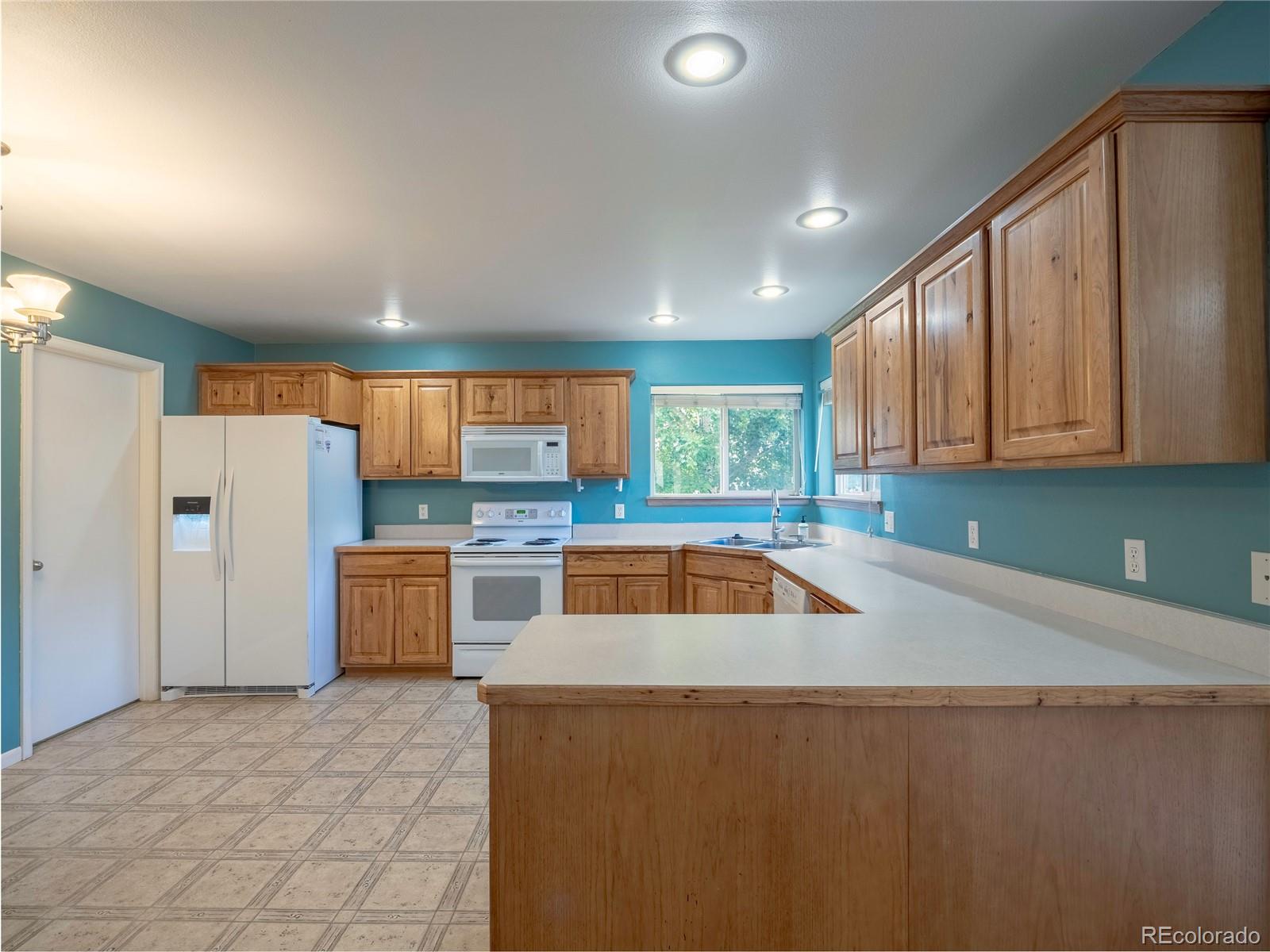 1436 H Street, Unit D Salida, CO 81201 - Photo 14 of 31 a kitchen with a refrigerator and a sink