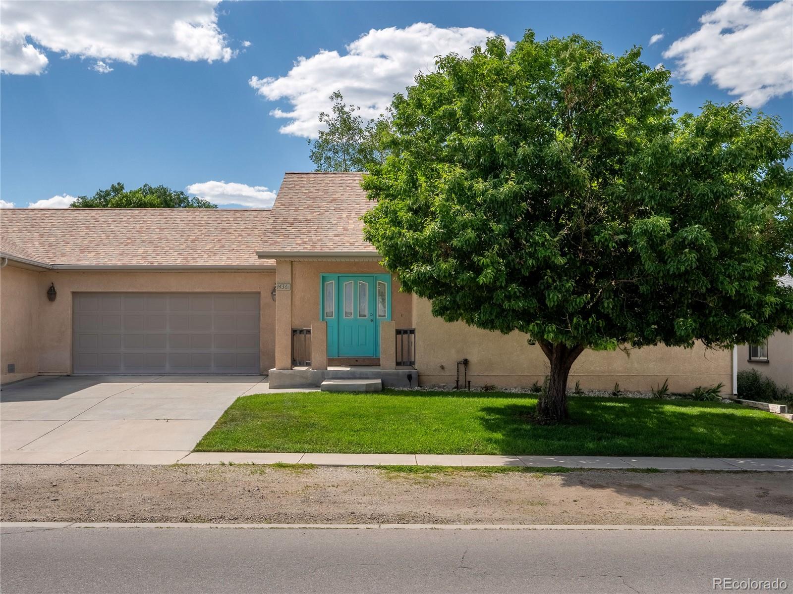 1436 H Street, Unit D Salida, CO 81201 - Photo 25 of 31 a front view of a house with a garden and a tree