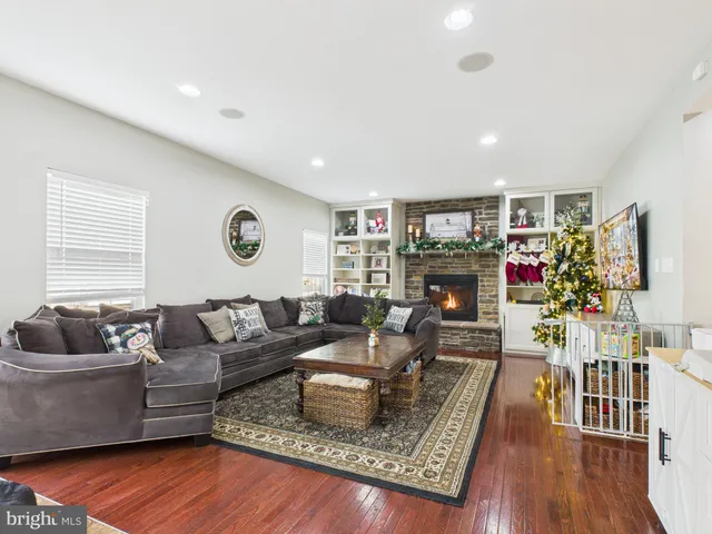 a living room with furniture fireplace and a large window