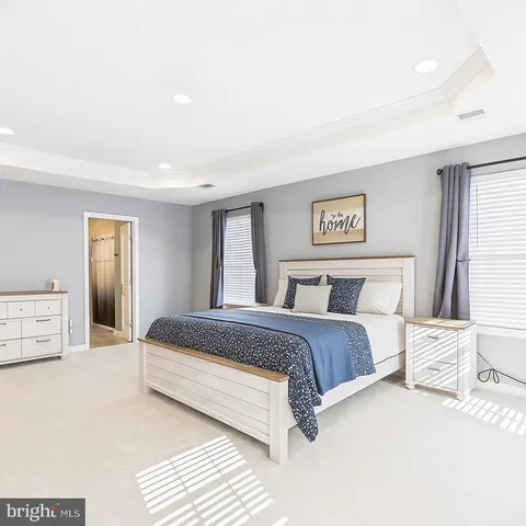 a spacious bedroom with a large bed and a couch