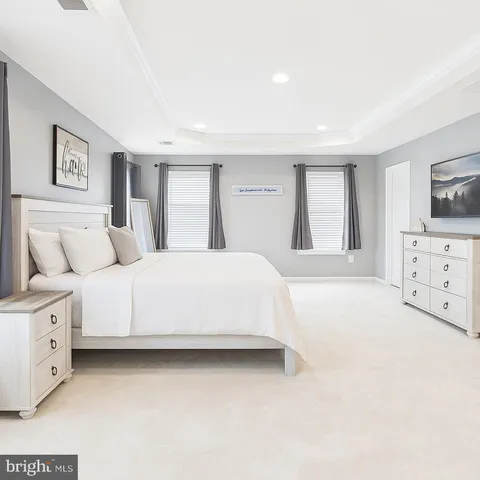 a large white bed in a white room