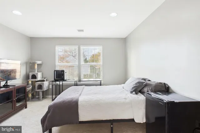 a bedroom with a bed and a table