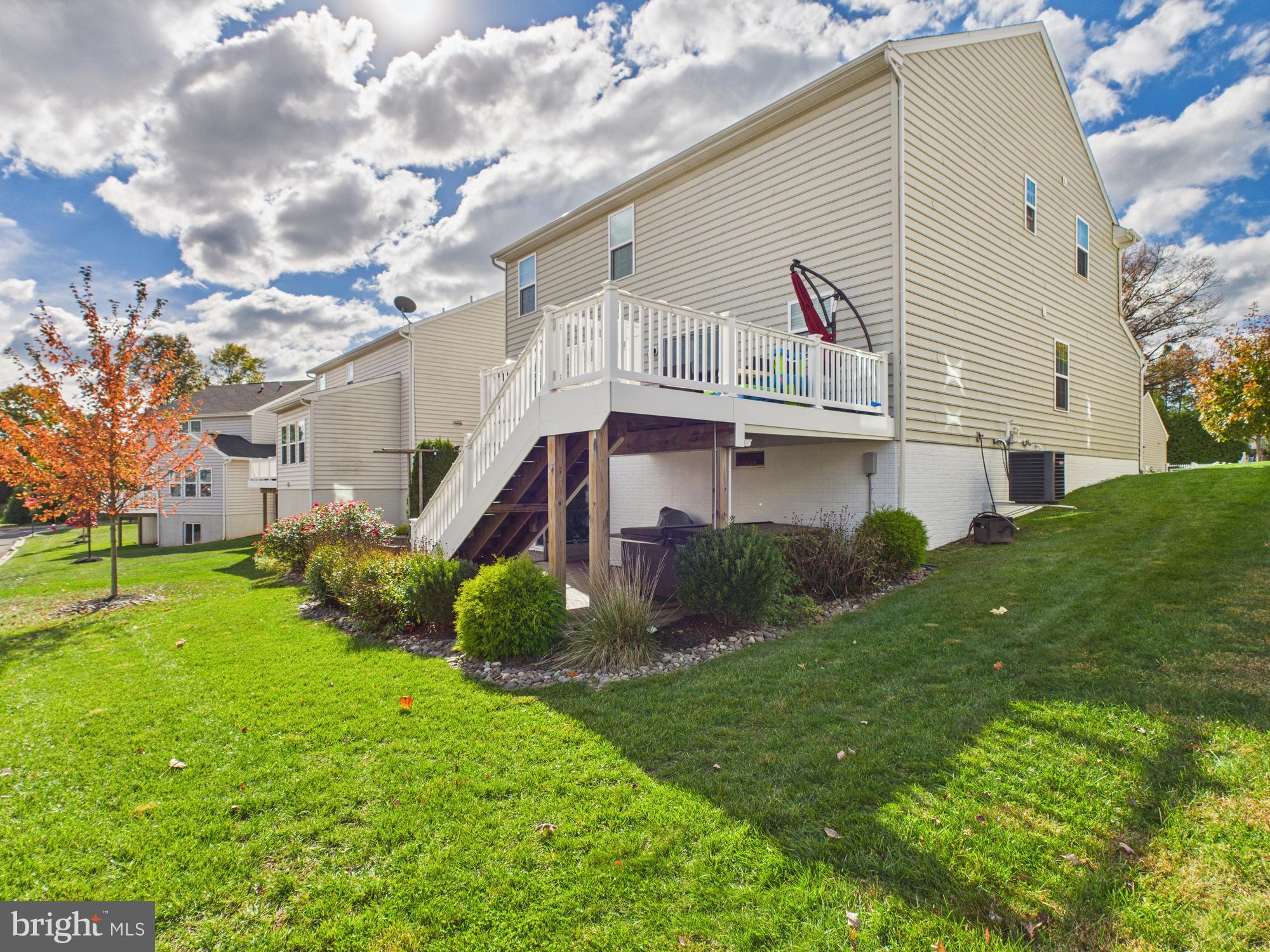 5 Madison Drive Spring City, PA 19475 - Photo 28 of 36 a view of a white house next to a yard with big trees