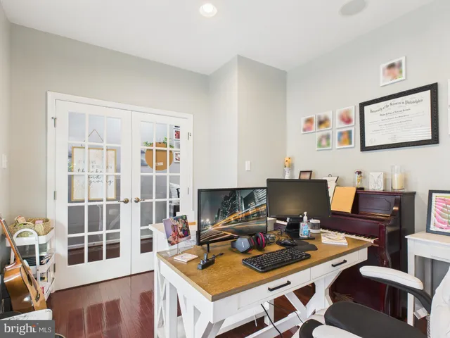a view of a workspace with furniture and a window