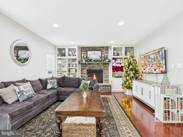 a living room with furniture a flat screen tv and a floor to ceiling window