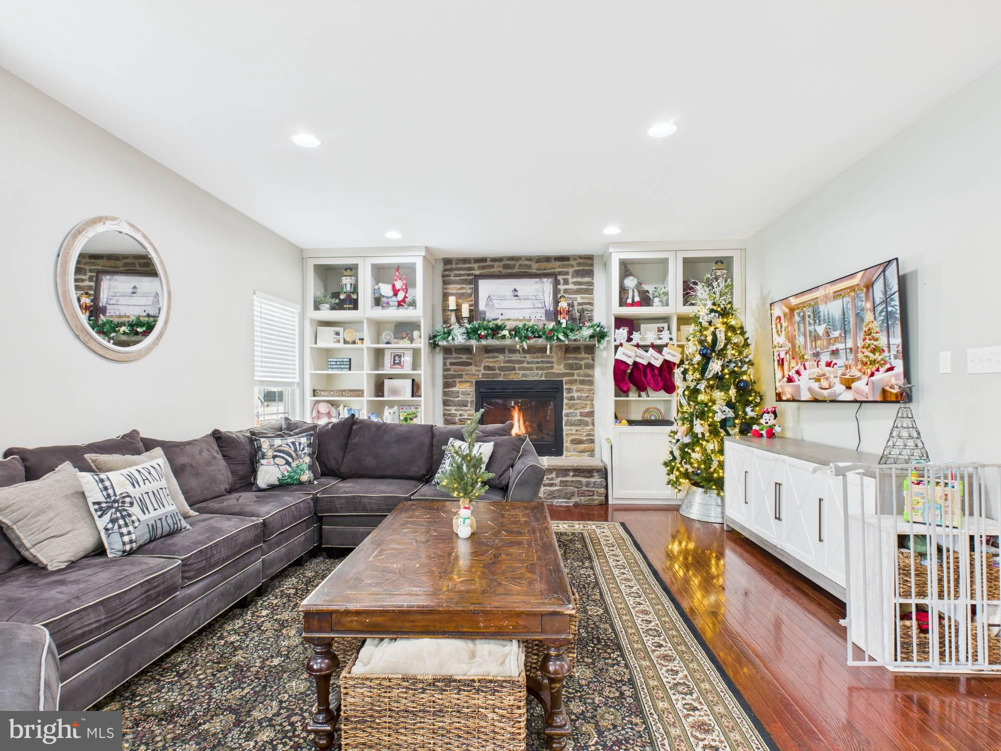 5 Madison Drive Spring City, PA 19475 - Photo 10 of 36 a living room with furniture a flat screen tv and a floor to ceiling window