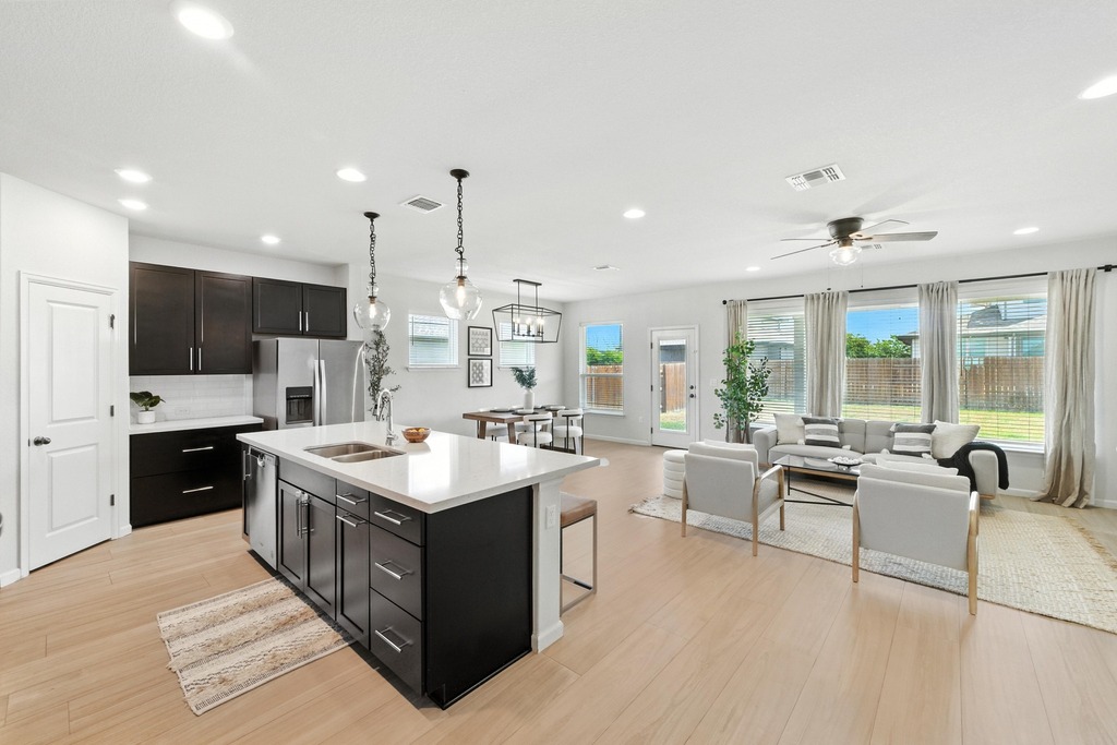 8117 Bestride Bend Austin, TX 78744 - Photo 40 of 40 a kitchen with kitchen island a sink a counter top space stainless steel appliances and a large window