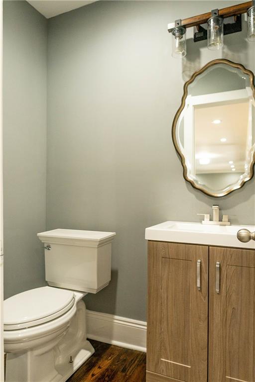 1433 Merriman Lane Northeast Atlanta, GA 30324 - Photo 12 of 60 a bathroom with a toilet sink vanity and mirror