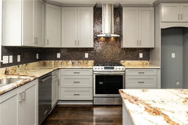 a kitchen with kitchen island granite countertop a sink and cabinets