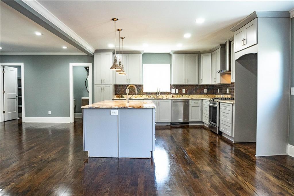 1433 Merriman Lane Northeast Atlanta, GA 30324 - Photo 18 of 60 a kitchen with stainless steel appliances granite countertop a stove a sink a refrigerator and a microwave