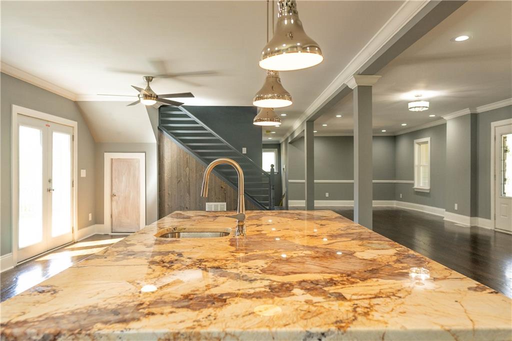 1433 Merriman Lane Northeast Atlanta, GA 30324 - Photo 21 of 60 a large bedroom with a bed and a chandelier