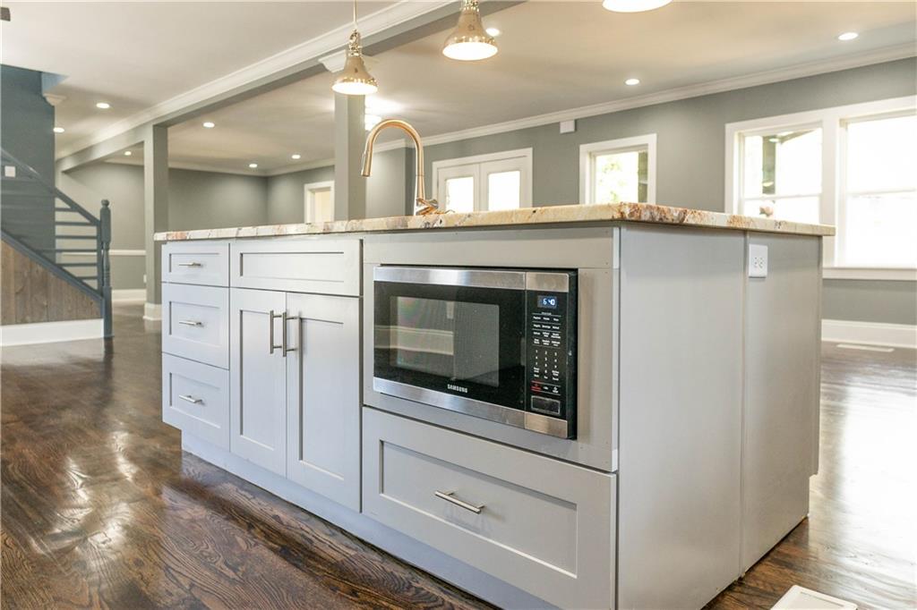 1433 Merriman Lane Northeast Atlanta, GA 30324 - Photo 22 of 60 a kitchen with white cabinets and white appliances