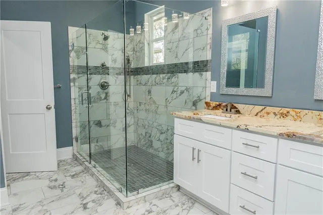 a bathroom with a sink a mirror and a vanity
