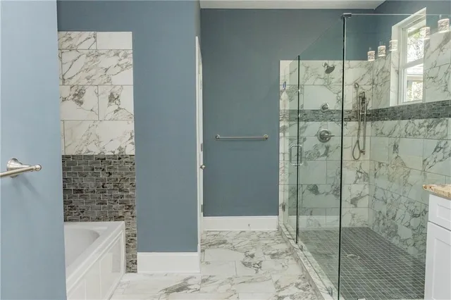 a view of an empty room with a window and a ceiling fan