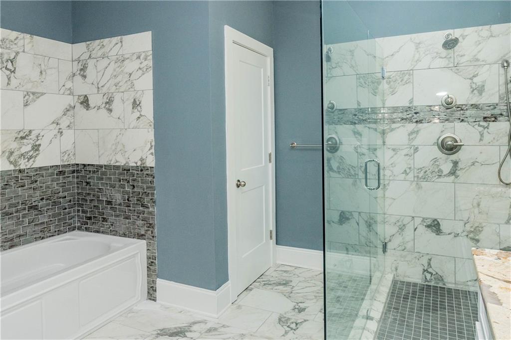 1433 Merriman Lane Northeast Atlanta, GA 30324 - Photo 40 of 60 a bathroom with a bathtub and shower