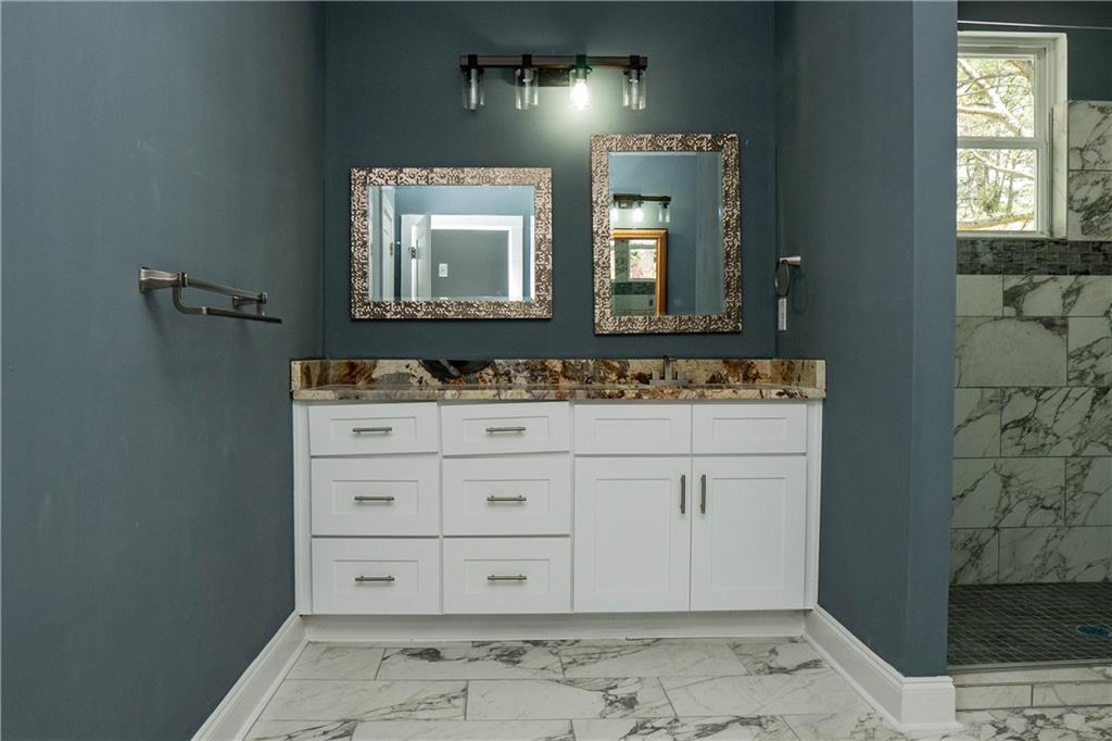 1433 Merriman Lane Northeast Atlanta, GA 30324 - Photo 44 of 60 a bathroom with a sink a mirror and a vanity