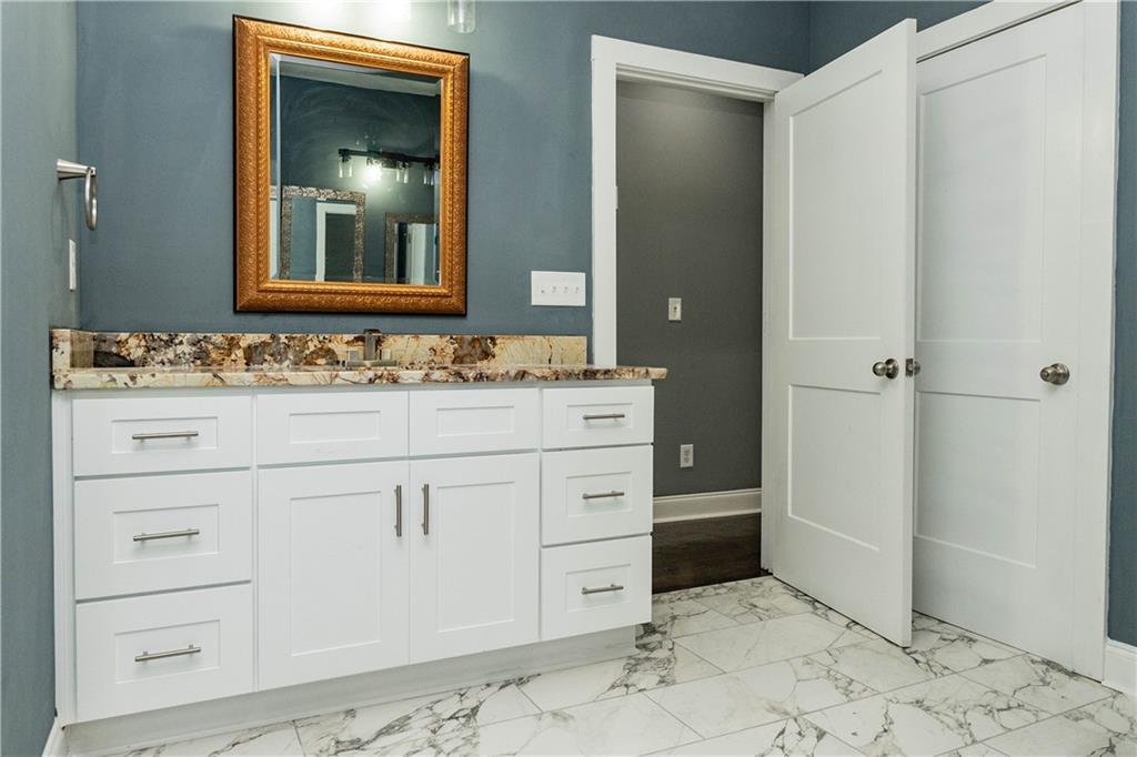 1433 Merriman Lane Northeast Atlanta, GA 30324 - Photo 46 of 60 a bathroom with a sink and a mirror