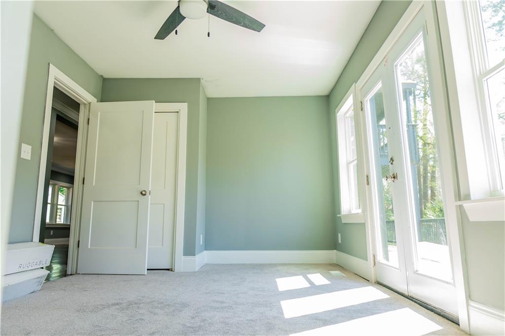 1433 Merriman Lane Northeast Atlanta, GA 30324 - Photo 47 of 60 a view of an empty room with a window and a ceiling fan