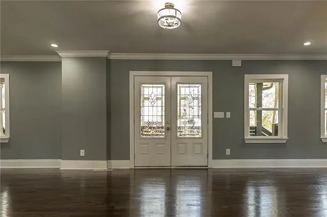 a view of an entryway with wooden floor and windows