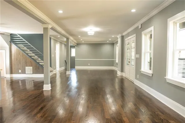 a kitchen with granite countertop white cabinets and stainless steel appliances