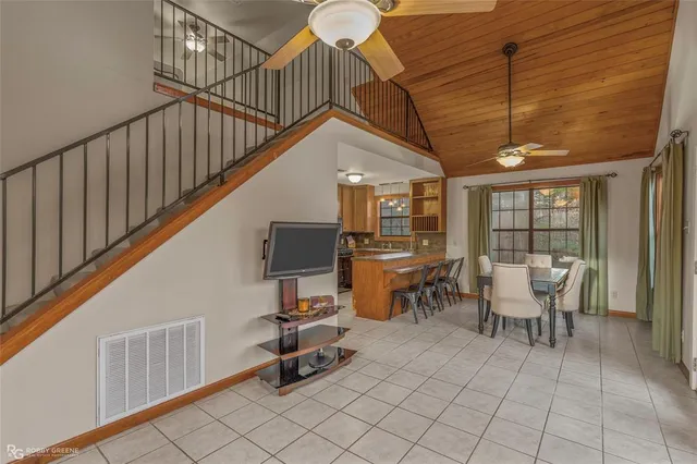 a dining room with furniture a chandelier and wooden floor