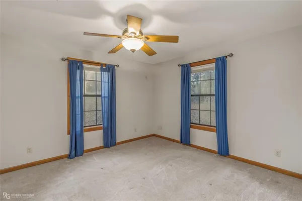 a bathroom with a granite countertop toilet a sink and a mirror