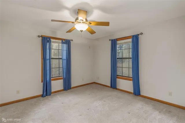 a bathroom with a granite countertop toilet a sink and a mirror