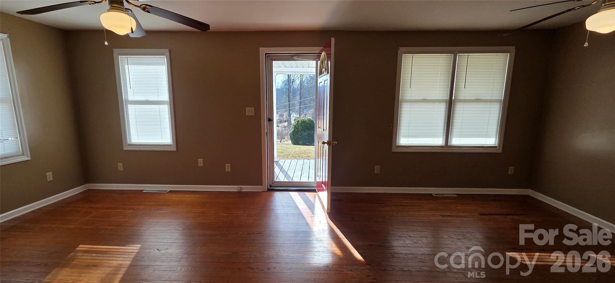 212 Old Dale Road Spruce Pine, NC 28777 - Photo 16 of 30 an empty room with wooden floor and windows