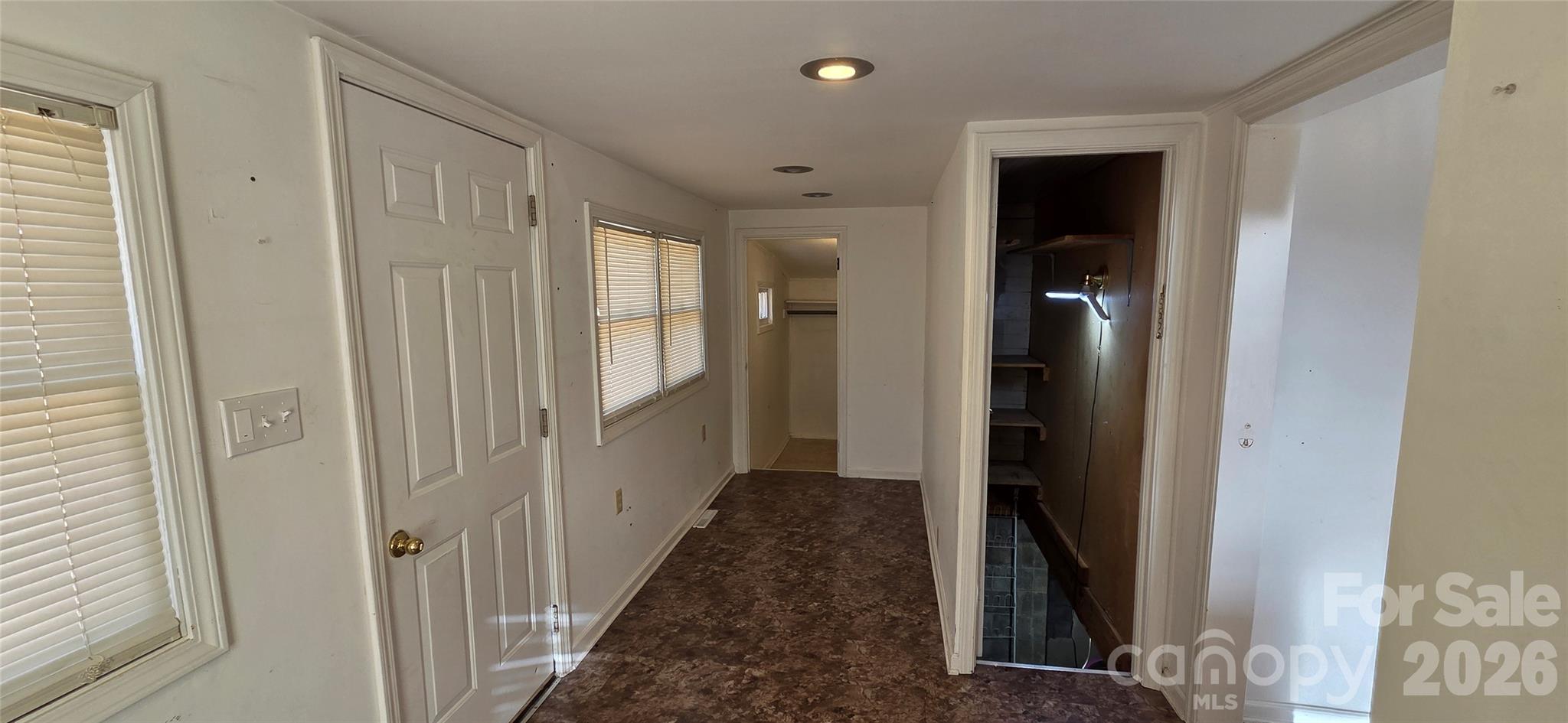 212 Old Dale Road Spruce Pine, NC 28777 - Photo 20 of 30 a view of a hallway with wooden floor and staircase