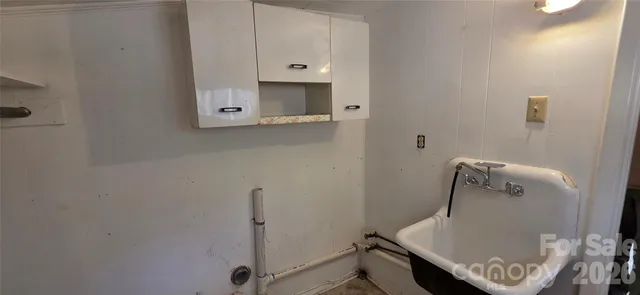 view of a room with utility and racks on the wall