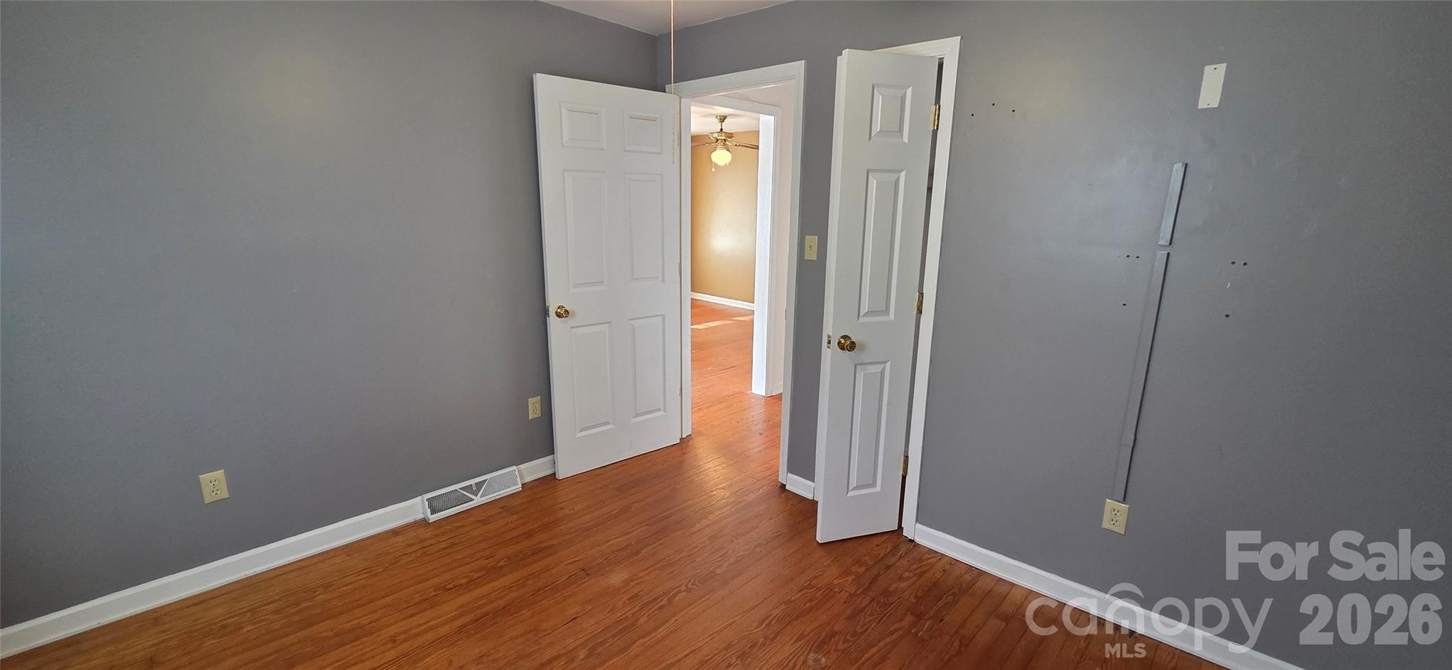212 Old Dale Road Spruce Pine, NC 28777 - Photo 22 of 30 a view of an empty room with wooden floor and a window