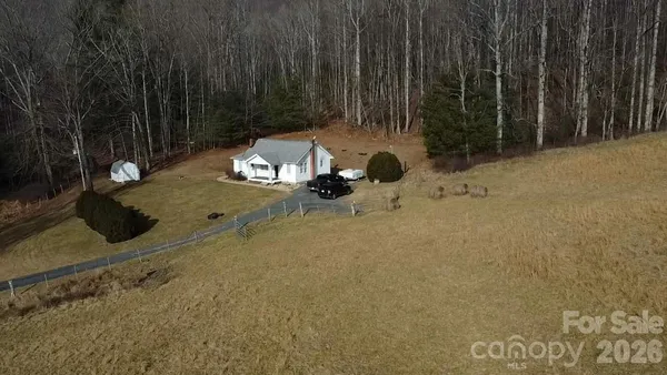 a view of a backyard with table and chairs