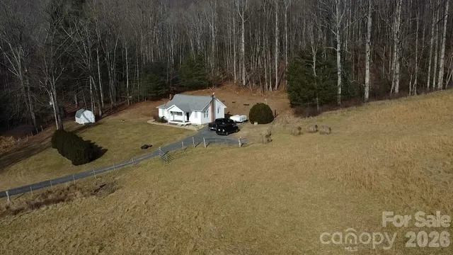 a view of a backyard with table and chairs