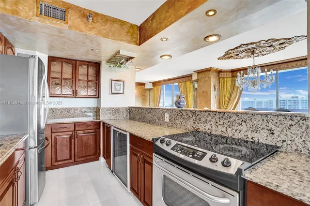 a kitchen with stainless steel appliances granite countertop a stove and a sink