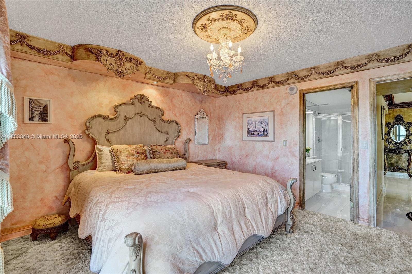 3530 Mystic Pointe Drive, Unit 2915 Aventura, FL 33180 - Photo 14 of 41 a bedroom with a bed and a chandelier