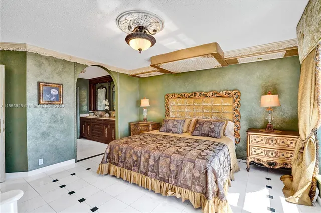 a bedroom with a bed and a chandelier