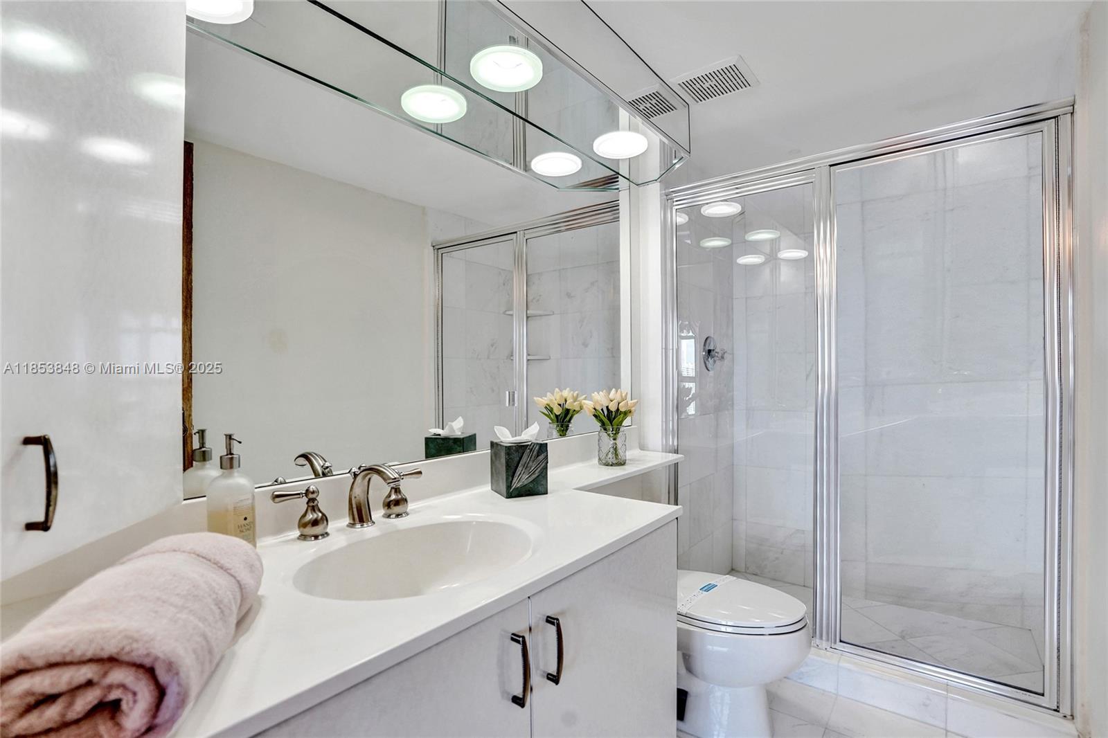 3530 Mystic Pointe Drive, Unit 2915 Aventura, FL 33180 - Photo 20 of 41 a bathroom with a sink toilet and shower