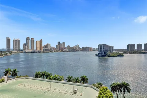 a view of a lake with tall buildings