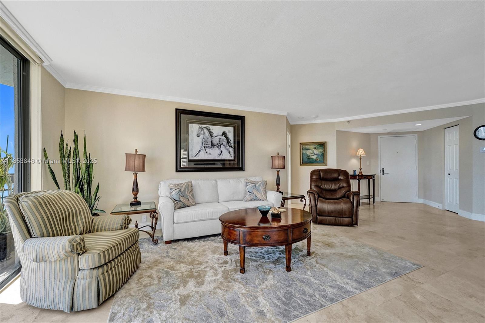 3530 Mystic Pointe Drive, Unit 2915 Aventura, FL 33180 - Photo 31 of 41 a living room with furniture and a large window