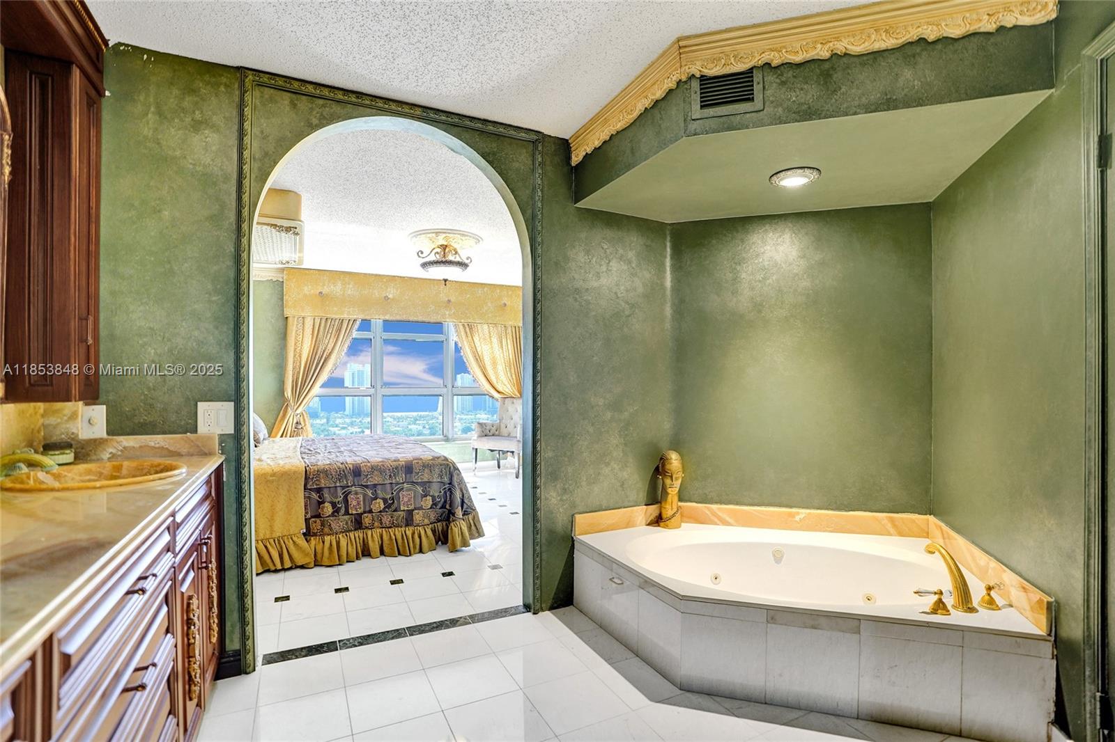 3530 Mystic Pointe Drive, Unit 2915 Aventura, FL 33180 - Photo 4 of 41 a bathroom with a tub a sink and glass door