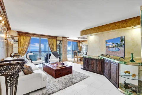 a living room with furniture and a floor to ceiling window