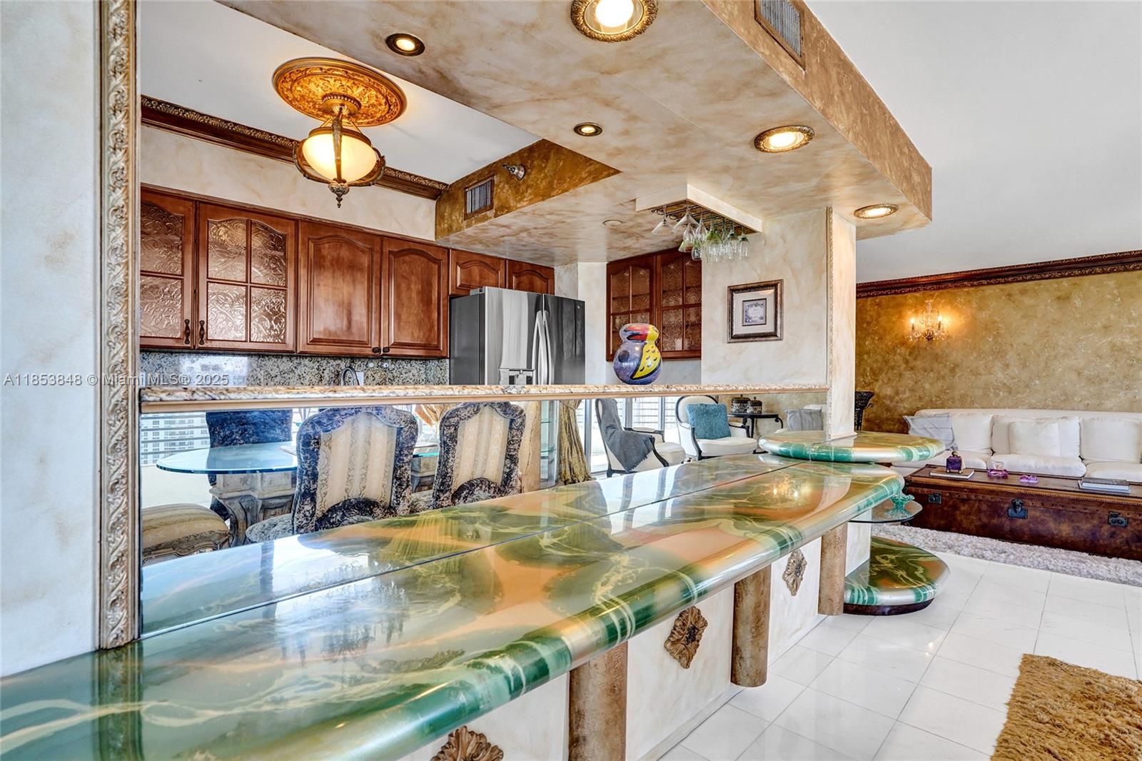 3530 Mystic Pointe Drive, Unit 2915 Aventura, FL 33180 - Photo 9 of 41 a kitchen with a stove a cabinets and living room view