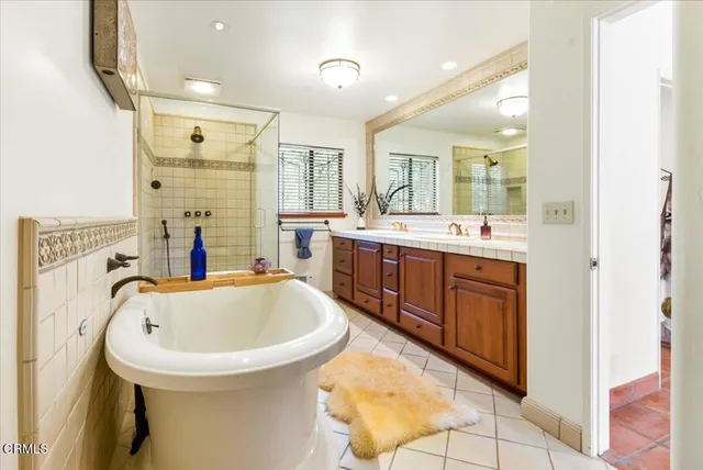 a living room with fireplace furniture and a floor to ceiling window