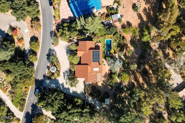 an aerial view of a house with a yard basket ball court and outdoor seating