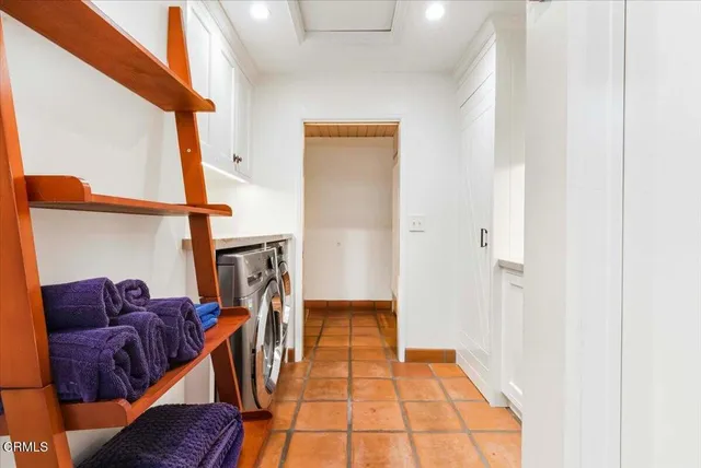 a backyard of a house with large trees and outdoor seating